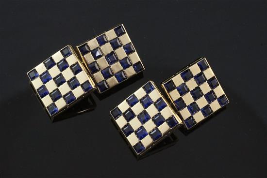 A pair of gold and sapphire set chequered cufflinks, 0.5in.